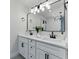 Modern bathroom vanity featuring double sinks, sleek black fixtures, and stylish lighting at 2272 Adam Ct, Palm Harbor, FL 34683
