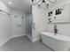 Spa-like bathroom featuring a freestanding tub, glass-enclosed shower, and modern black accents at 2272 Adam Ct, Palm Harbor, FL 34683