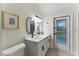 Bathroom boasts double vanity with modern fixtures, decor, and a glass door to the exterior at 2272 Adam Ct, Palm Harbor, FL 34683