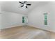 Bright bedroom featuring new flooring, ceiling fan, and natural light from multiple windows at 2272 Adam Ct, Palm Harbor, FL 34683