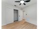Bedroom featuring new flooring, closet, and an adjacent door at 2272 Adam Ct, Palm Harbor, FL 34683