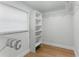 Well-organized closet featuring shelving and hanging rods for optimal storage, and a window for natural light at 2272 Adam Ct, Palm Harbor, FL 34683