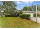 Charming home showcasing a well-manicured lawn and lush hedges that enhance the property's curb appeal at 2272 Adam Ct, Palm Harbor, FL 34683