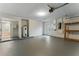 Spacious garage with painted floor, water heater, and storage shelving at 2272 Adam Ct, Palm Harbor, FL 34683