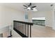 Bright hallway with hardwood floors and a modern black railing, offering a stylish and airy transition space at 2272 Adam Ct, Palm Harbor, FL 34683