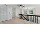 Bright hallway featuring hardwood floors, black staircase, and modern lighting fixtures at 2272 Adam Ct, Palm Harbor, FL 34683