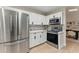 Modern kitchen with stainless steel appliances, white cabinets, and a stylish backsplash at 2272 Adam Ct, Palm Harbor, FL 34683