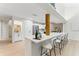 Open concept kitchen with long island, white cabinetry, and stainless steel appliances at 2272 Adam Ct, Palm Harbor, FL 34683
