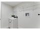 Clean laundry room with utility sink, modern faucet and wire rack shelving for storage at 2272 Adam Ct, Palm Harbor, FL 34683