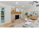Bright living room with brick fireplace, wood mantel, and modern furnishings at 2272 Adam Ct, Palm Harbor, FL 34683