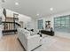 Spacious living room showcases hardwood floors, a staircase, and a comfortable sofa, perfect for modern living at 2272 Adam Ct, Palm Harbor, FL 34683