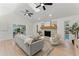 Spacious living room with a brick fireplace, high ceilings, and a ceiling fan at 2272 Adam Ct, Palm Harbor, FL 34683