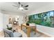 Bright home office with a large window overlooking the backyard and modern furnishings at 2272 Adam Ct, Palm Harbor, FL 34683