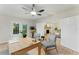 A bright office space featuring a ceiling fan, glass doors and modern furnishings at 2272 Adam Ct, Palm Harbor, FL 34683
