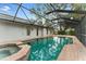 Pool with an enclosed screen, spa and covered area for entertaining at 2272 Adam Ct, Palm Harbor, FL 34683