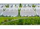 Aerial view of new townhomes featuring private backyards, landscaping, and parking at 2435 Foggy Creek Cir, Clearwater, FL 33764