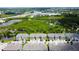 Aerial view of new construction townhomes with lush landscaping and a community pond at 2435 Foggy Creek Cir, Clearwater, FL 33764