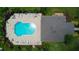 Aerial view of the community pool with chairs and umbrellas, located next to the clubhouse at 2435 Foggy Creek Cir, Clearwater, FL 33764