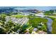 Aerial view showcases community, landscaping, waterways, and nearby city skyline at 2435 Foggy Creek Cir, Clearwater, FL 33764