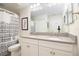 Bathroom featuring double sinks with a large mirror and white cabinets at 2435 Foggy Creek Cir, Clearwater, FL 33764
