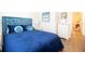 Bedroom featuring plush blue bedding, hardwood floors, and a white dresser at 2435 Foggy Creek Cir, Clearwater, FL 33764