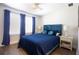 Comfortable bedroom with hardwood floors, large window, and stylish decor at 2435 Foggy Creek Cir, Clearwater, FL 33764