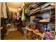 Walk-in closet featuring custom shelving, ample storage, and wood-look floors at 2435 Foggy Creek Cir, Clearwater, FL 33764