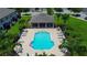 Community pool area featuring lounge chairs, tables, umbrellas, and a covered pavilion with seating at 2435 Foggy Creek Cir, Clearwater, FL 33764