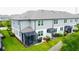 An exterior shot shows screened patios that allows outdoor cooking, along with yard and privacy fencing at 2435 Foggy Creek Cir, Clearwater, FL 33764