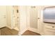 Hallway with a pantry featuring a frosted glass door and tiled backsplash at 2435 Foggy Creek Cir, Clearwater, FL 33764