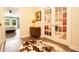 Inviting hallway with hardwood floors, leading to bedrooms and a home office with French doors at 2435 Foggy Creek Cir, Clearwater, FL 33764