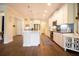 Open-concept kitchen with island, stainless steel appliances, and elegant pendant lighting at 2435 Foggy Creek Cir, Clearwater, FL 33764
