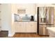 Butler's pantry with custom cabinetry, stainless steel appliances, and tiled backsplash at 2435 Foggy Creek Cir, Clearwater, FL 33764