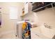 Laundry room featuring washer and dryer with sink and shelving at 2435 Foggy Creek Cir, Clearwater, FL 33764
