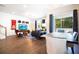 Open concept living and dining area with hardwood floors, modern decor, and abundant natural light at 2435 Foggy Creek Cir, Clearwater, FL 33764