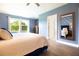 Comfortable bedroom with a large window, hardwood floors, and stylish decor at 2435 Foggy Creek Cir, Clearwater, FL 33764