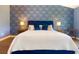 Elegantly decorated bedroom with a plush bed, stylish wallpaper, and ample lighting at 2435 Foggy Creek Cir, Clearwater, FL 33764