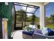 Relaxing screened patio with comfortable seating, lush greenery, and a tranquil water feature at 2435 Foggy Creek Cir, Clearwater, FL 33764