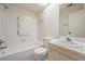 Clean bathroom featuring a tub-shower combo, white tile, and a single sink vanity at 2465 Northside Dr # 605, Clearwater, FL 33761