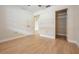 Bright bedroom featuring wood-look flooring, closet, and fresh paint at 2465 Northside Dr # 605, Clearwater, FL 33761