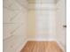 Walk-in closet with built-in shelving and laminate wood floor at 2465 Northside Dr # 605, Clearwater, FL 33761