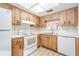 Spacious kitchen with wooden cabinets, white appliances, and tile flooring at 2465 Northside Dr # 605, Clearwater, FL 33761