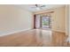 Living room with ceiling fan, wood-look flooring, and access to a screened lanai at 2465 Northside Dr # 605, Clearwater, FL 33761