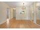 Open floor plan living room featuring wood-look flooring, a modern light, and a mirrored wall at 2465 Northside Dr # 605, Clearwater, FL 33761