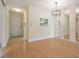 Large open space with a doorway and a mirrored wall, with light colored walls and wood-look flooring at 2465 Northside Dr # 605, Clearwater, FL 33761
