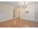Bright and spacious living room featuring wood-look flooring and a modern light fixture at 2465 Northside Dr # 605, Clearwater, FL 33761