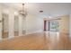 Spacious living room featuring wood-look flooring, a modern light, and sliding doors to the outside at 2465 Northside Dr # 605, Clearwater, FL 33761