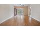 Sunlit living room features wood-look floors, ceiling fan, and sliding glass doors to the outside at 2465 Northside Dr # 605, Clearwater, FL 33761