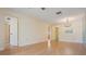 Large open space with a doorway and a mirrored wall, with light colored walls and wood-look flooring at 2465 Northside Dr # 605, Clearwater, FL 33761