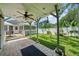 Backyard featuring a brick paved patio and grassy yard with mature landscaping and white vinyl fence at 2811 W Sitios St, Tampa, FL 33629